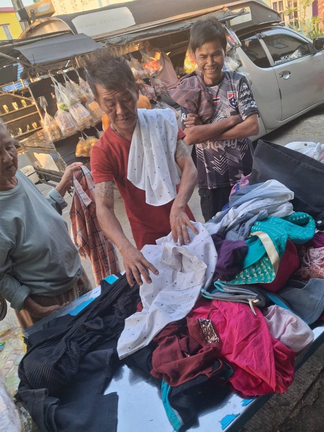 Community members choosing donated clothing and household goods in the slum zone.