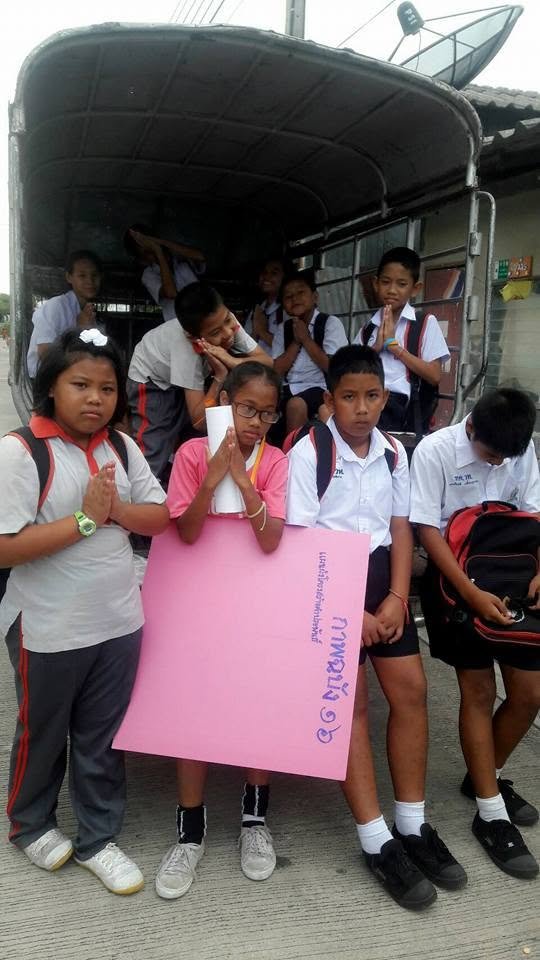 School children gathered by a van as part of the Thailand education sewa support.