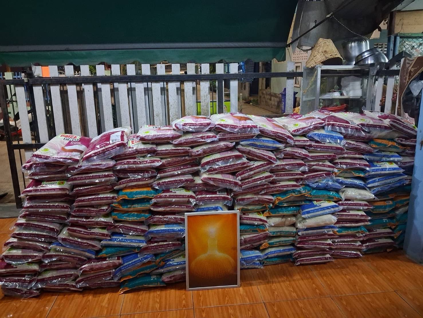 Stacks of rice bags prepared for distribution to slum communities in Thailand.